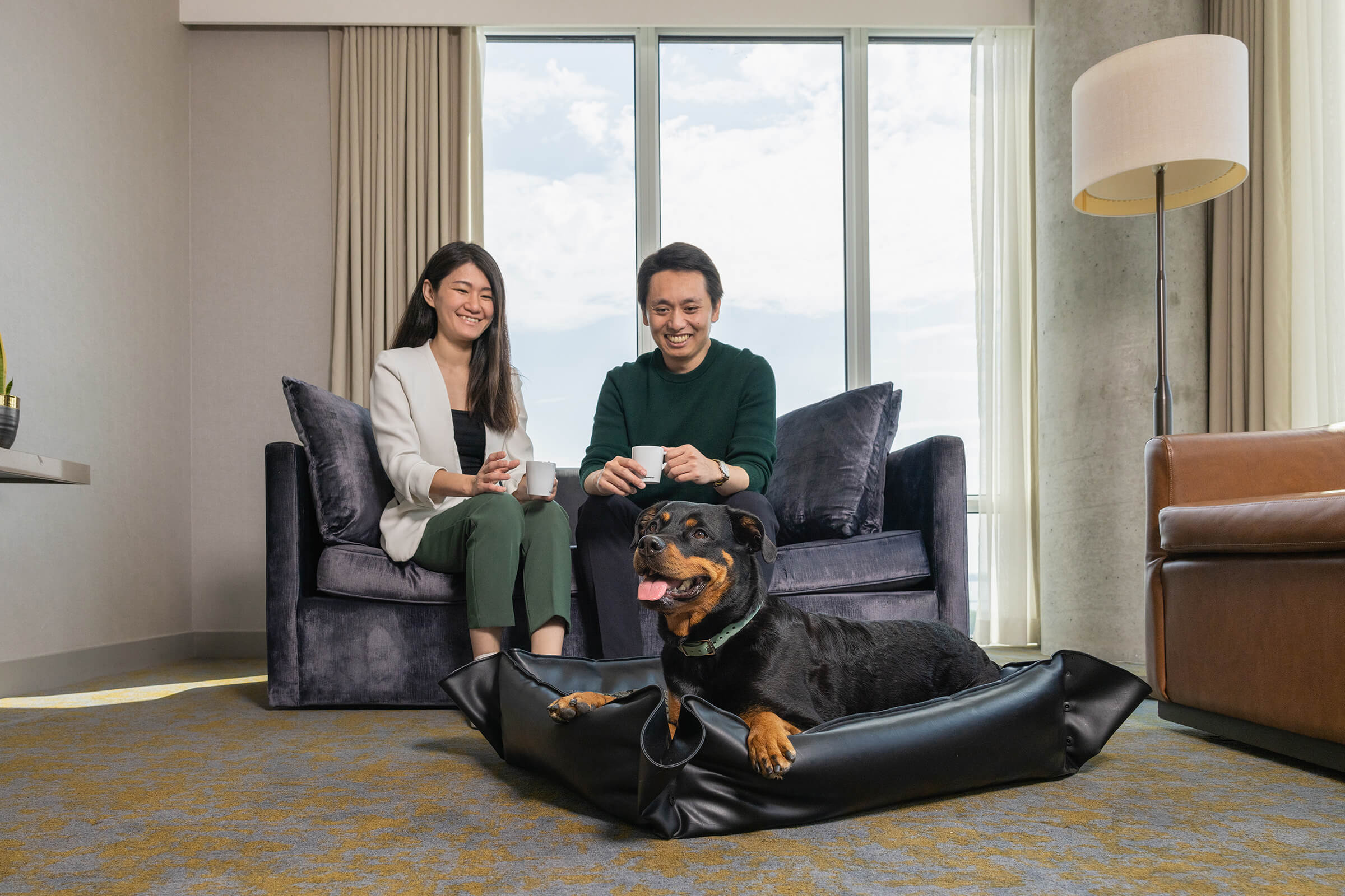 couple relaxing with dog in suite at Hotel X